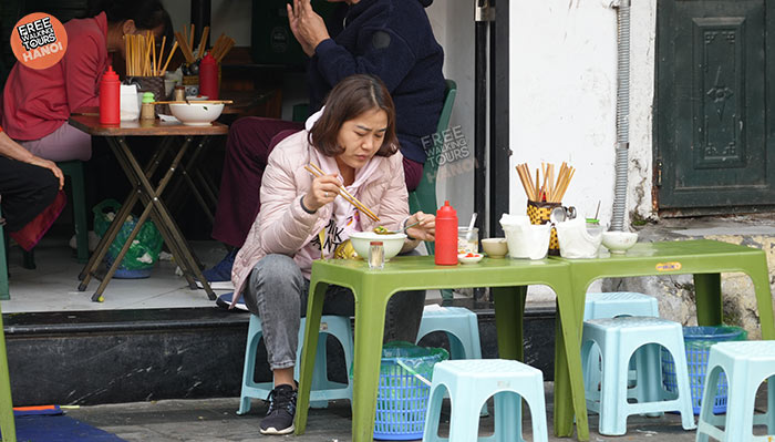 Locals lining up at a popular Hanoi food stall during lunch rush